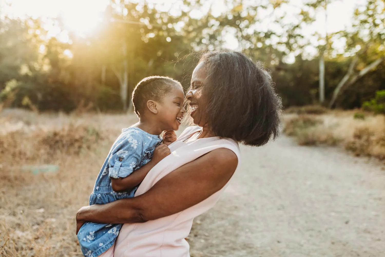 A woman holding her child and smiling